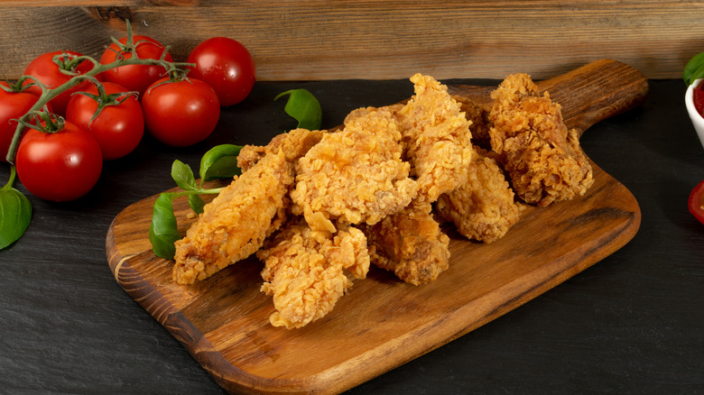 fried chicken breasts on a board