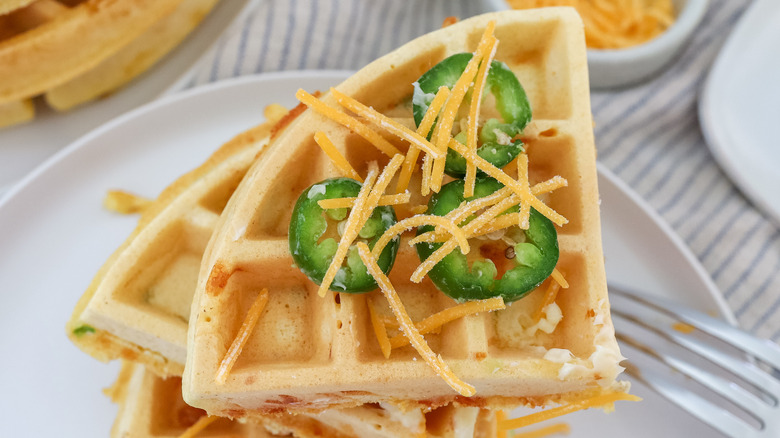 cut up jalapeño cheddar waffles on a plate