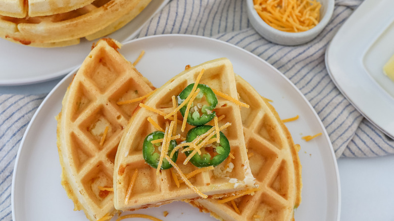 jalapeño cheddar waffles cut up on a plate