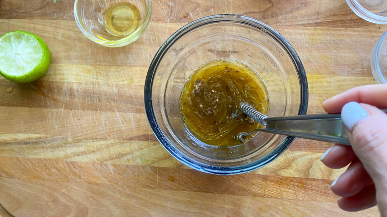 hand whisking dressing in bowl