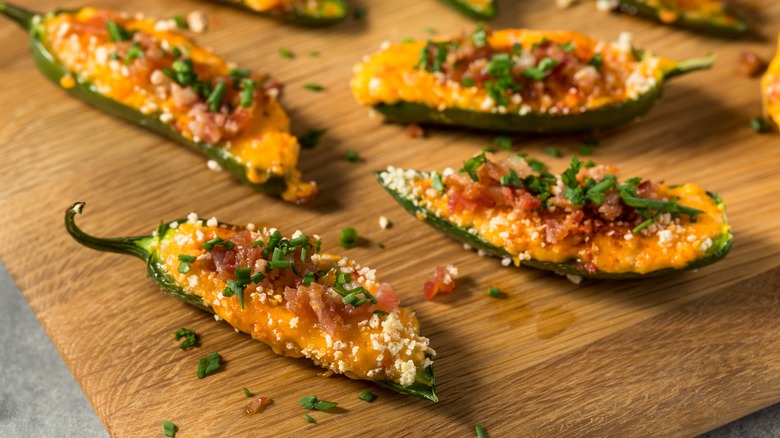 Homemade jalapeño poppers on a wooden board