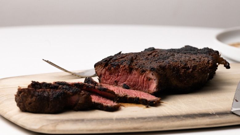 Slicing cooked sirloin steak 