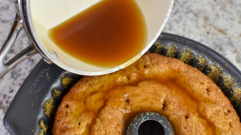 pouring syrup over cake