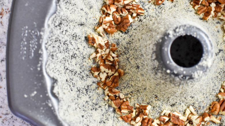 floured bundt pan with nuts