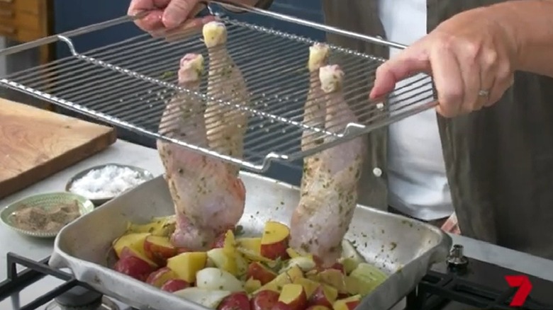 Chicken legs hanging from oven grates