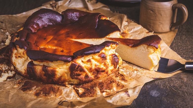 Slice being cut from a Basque cheesecake