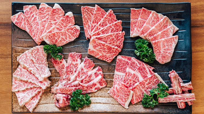 A5 wagyu cuts fanned out on cutting board