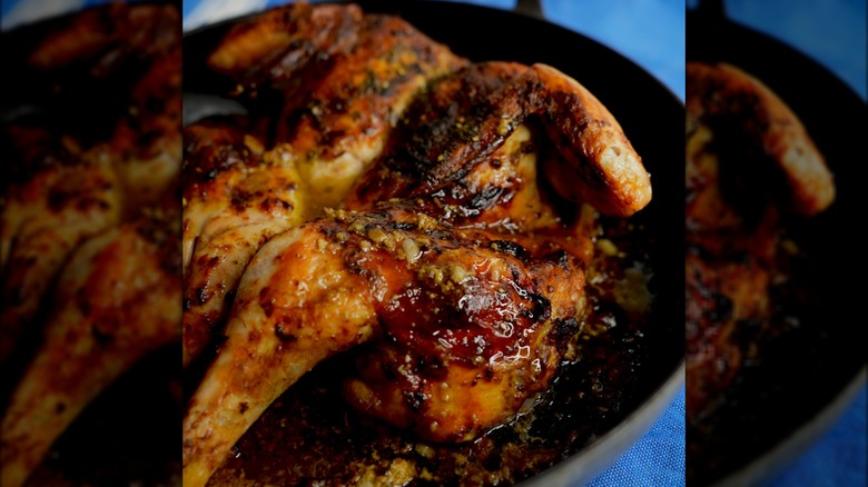 A roasted za'atar chicken in a pan