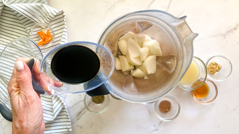 pouring soy sauce into the blender