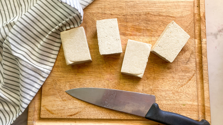 4 pieces of tofu on cutting board