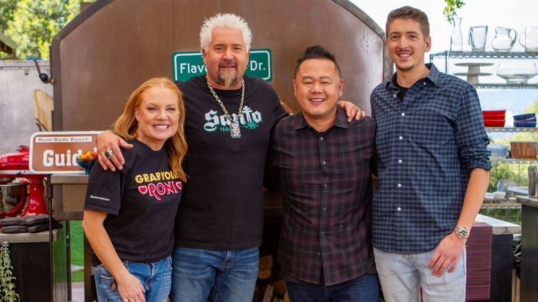 Guy Fieri and Jet Tila posing with chefs