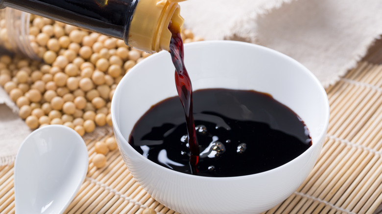 Pouring soy sauce into a bowl