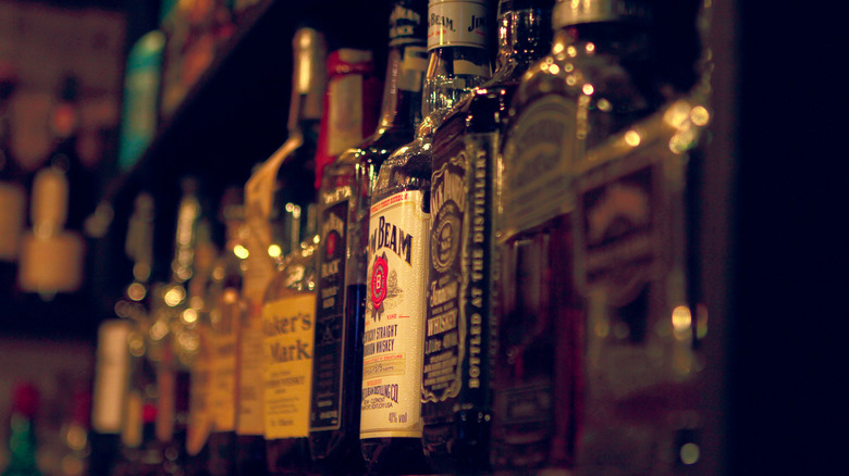 Line-up of whiskey bottles in a bar
