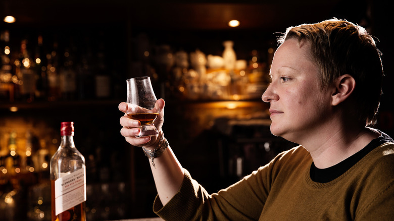 Woman holding whisky glass