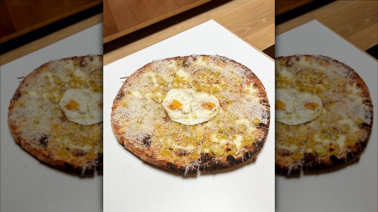 Over-easy egg on a pizza