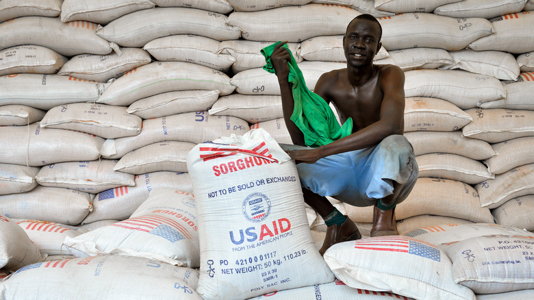 Man in front of bags of food from U.S.