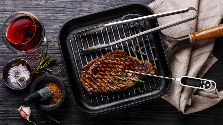 steak on grill with thermometer