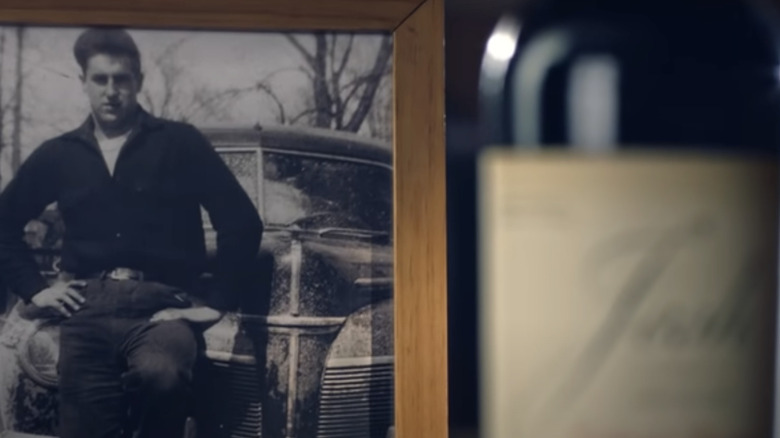 Picture frame behind wine bottle