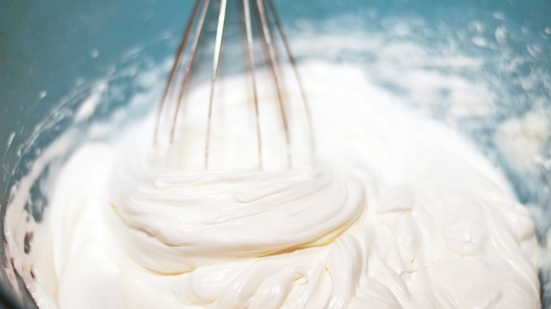 Whisking whipped cream in a bowl