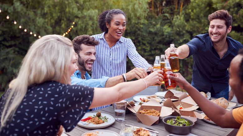 Friends toasting drinks outside