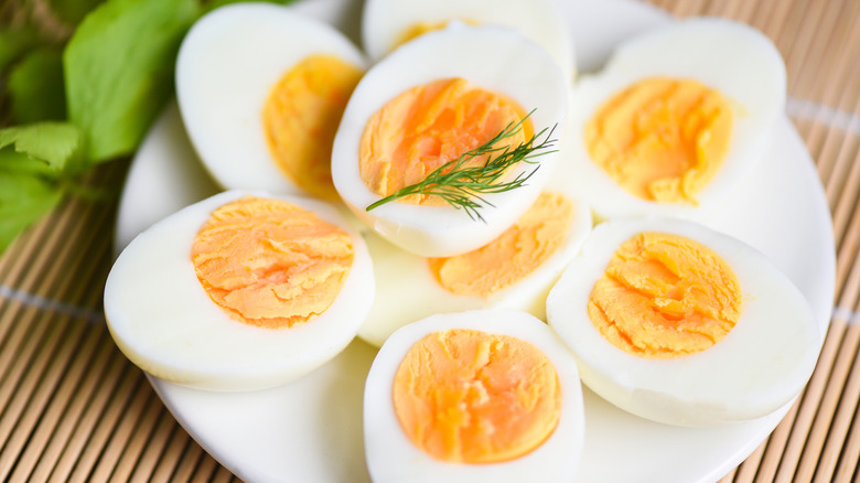 Halved hard-boiled eggs on plate