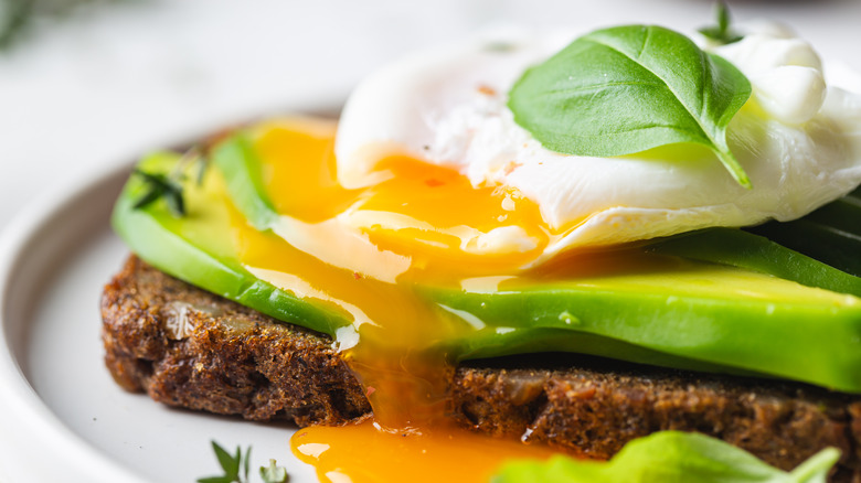 A perfectly poached egg on avocado toast