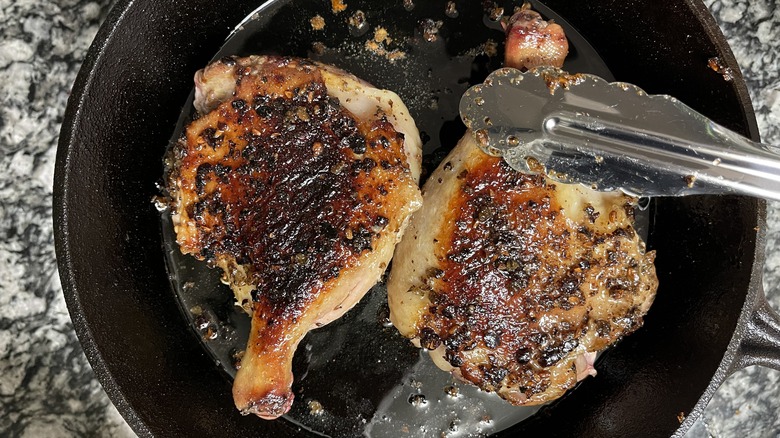 browned duck thighs in pan