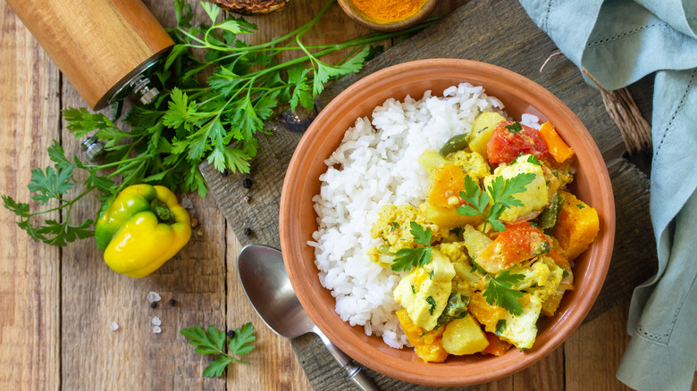 pumpkin curry served with additional vegetables and rice