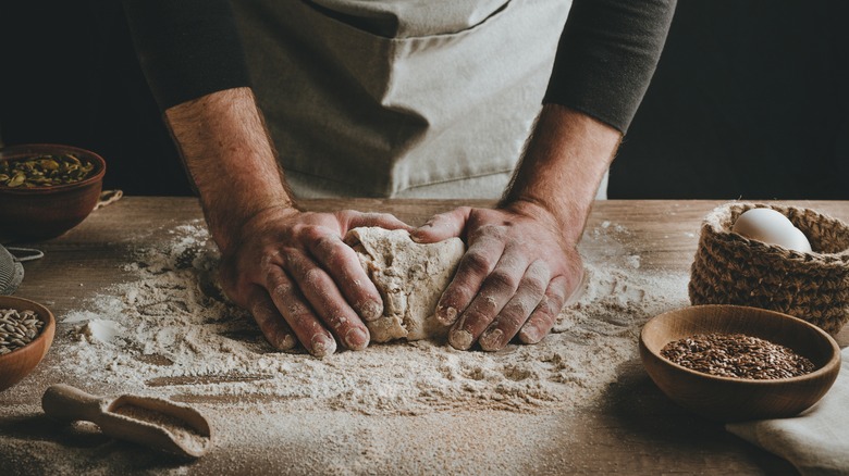 man kneading dough