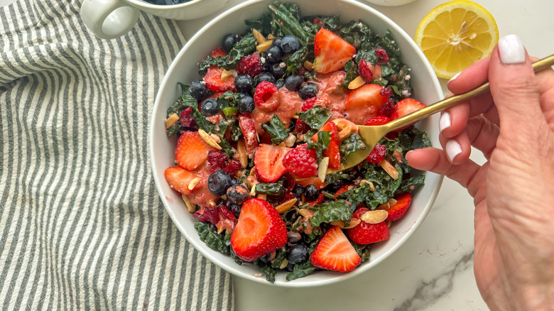 salad with hand holding fork