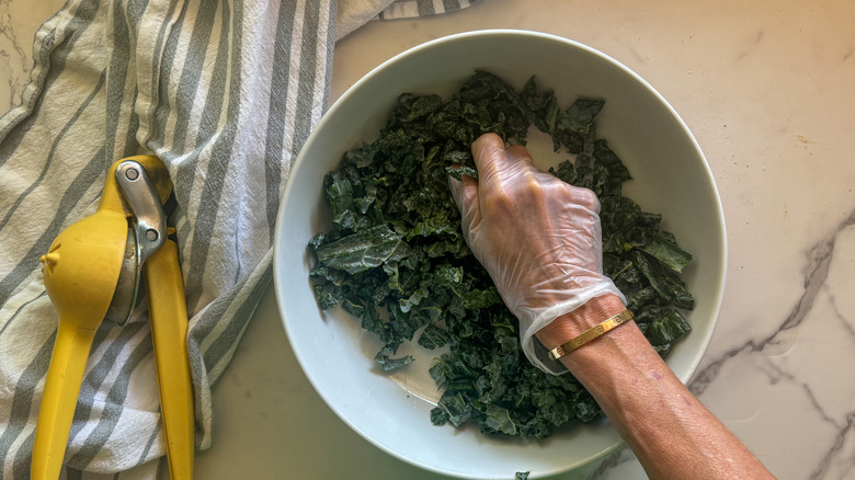 hand massaging kale