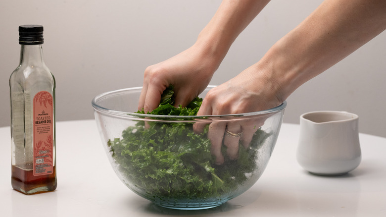 massaging kale with sesame oil