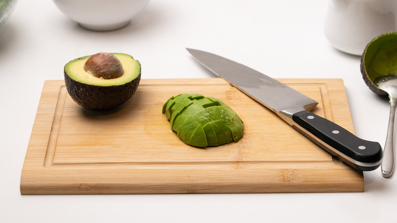 sliced avocado on chopping board