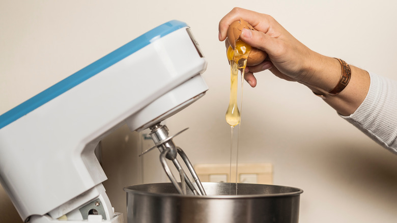 one-handed egg crack into mixer bowl