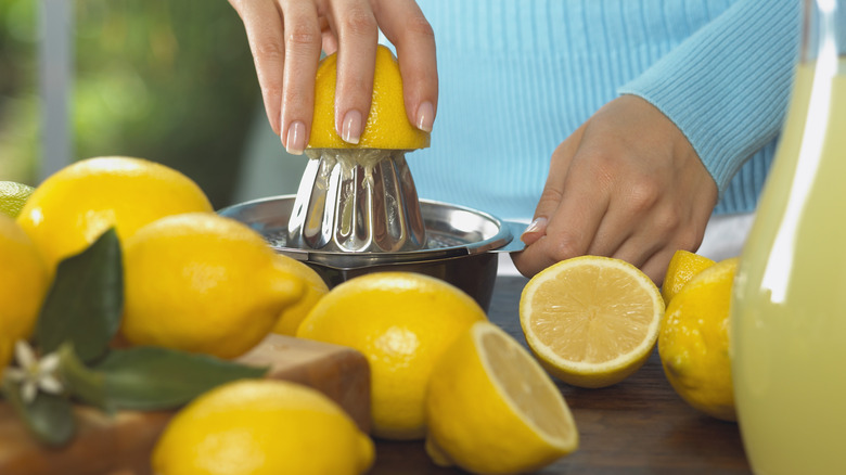 Person juicing lemons for lemonade