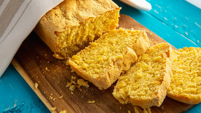 Cornbread sliced on wooden cutting board