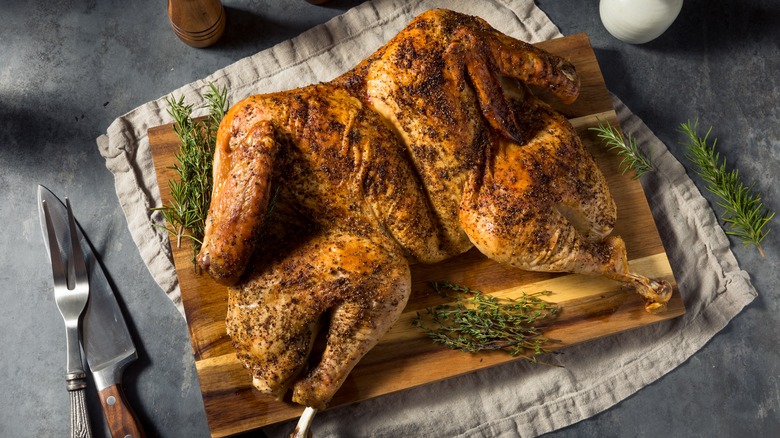 Spatchcocked poultry on cutting board