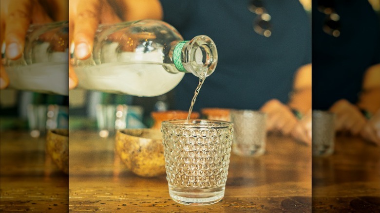 pouring mezcal agave spirit