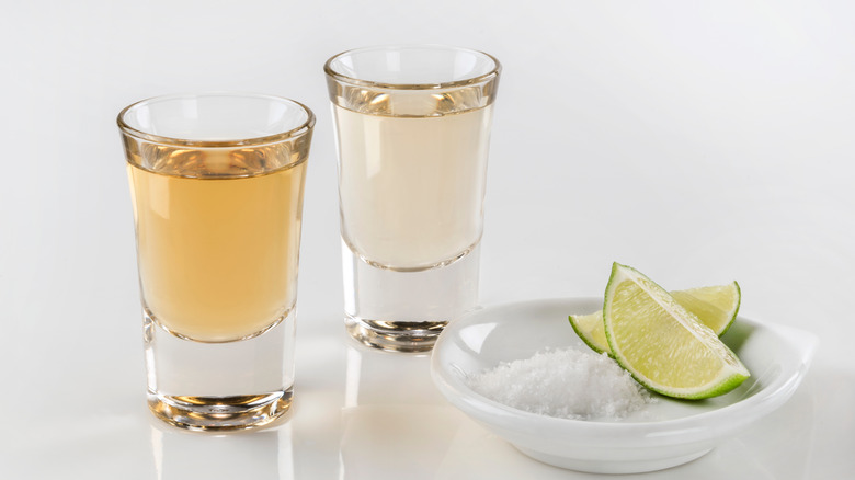 Two shots of agave with limes