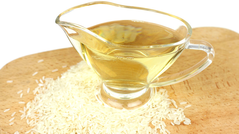 A pitcher of vinegar with uncooked rice