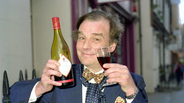 Keith Floyd holding wine 