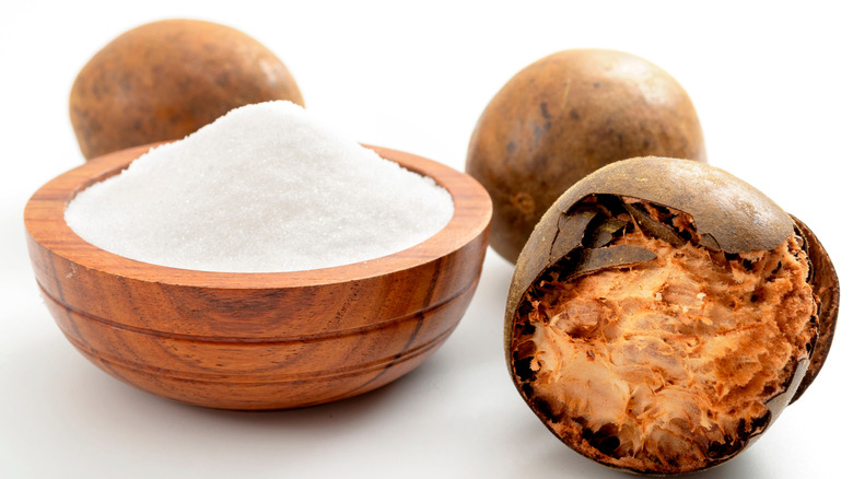 Monk fruit with bowl of monk fruit sweetener