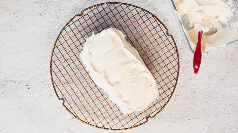 Cake on wire rack with frosting