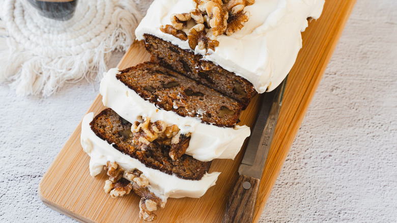 Sliced carrot cake with knife