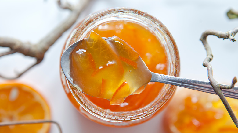 Orange marmalade spooned from jar