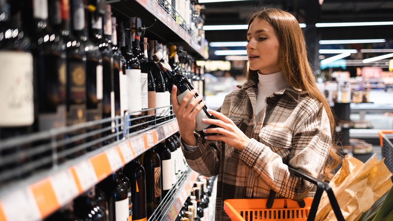 Person buying wine at store