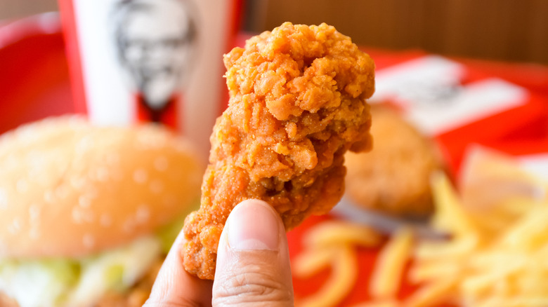 Persson holding piece of KFC chicken