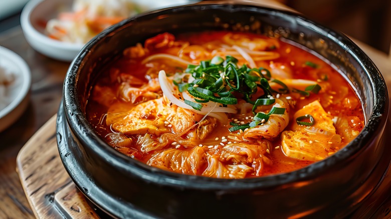 Kimchi jjigae in a black bowl