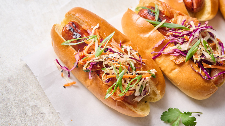 hot dog with kimchi on table