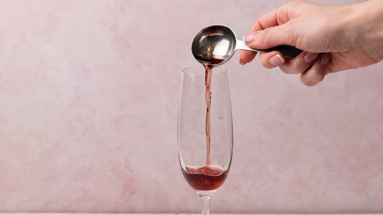 pouring chambord into a glass